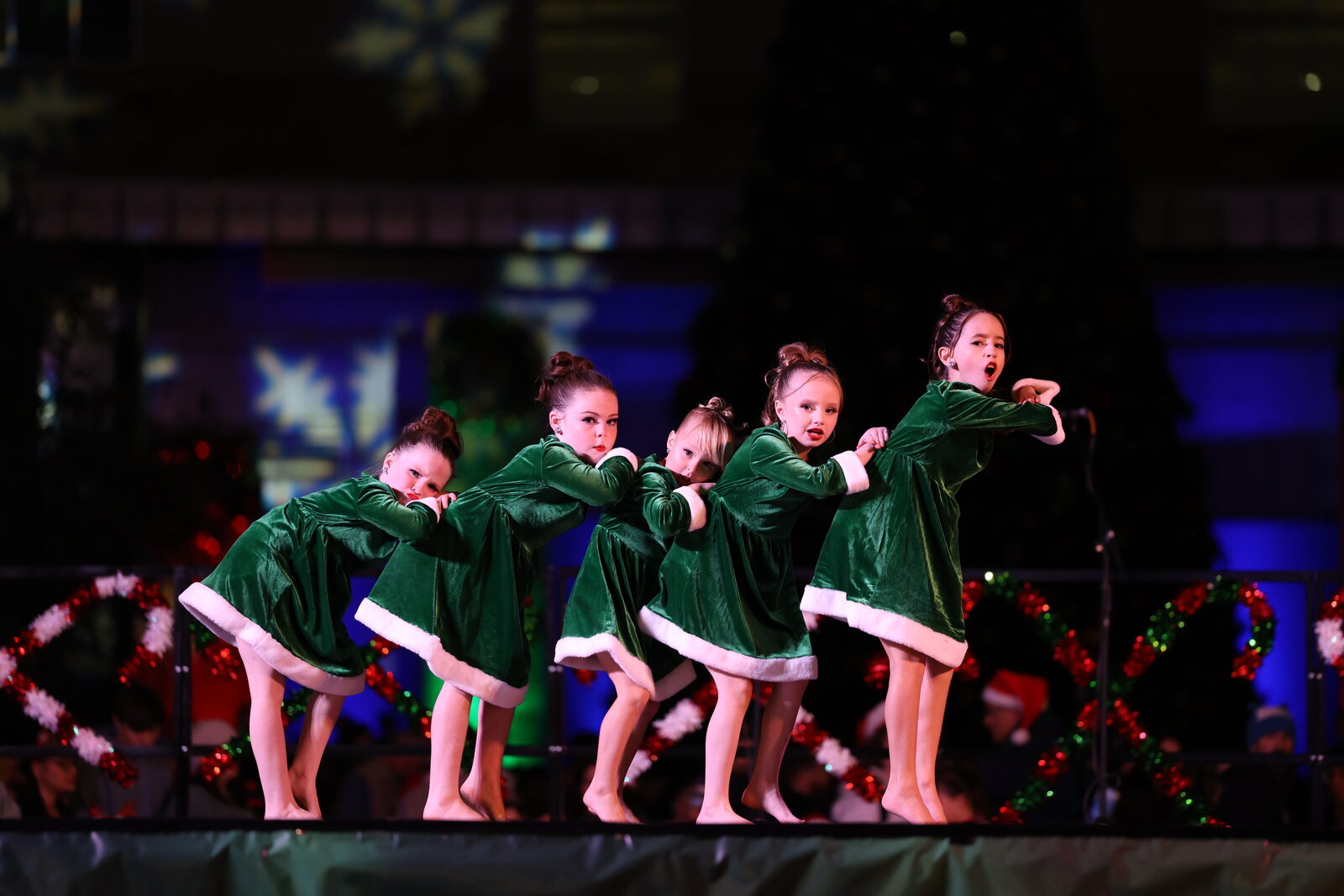 Group of Project 520 dancers performing together in green Christmas costumes